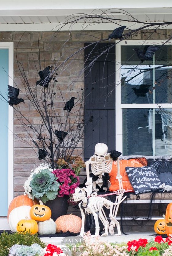 A cozy rustic Halloween scene with a skeleton petting its skeleton dog, blackbirds and jack o lanterns is lovely