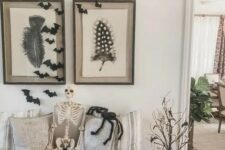 20 a rustic Halloween entryway with stacked white pumpkins, branches with lights, bats and a skeleton