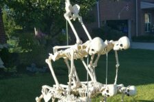 21 a creative and fun skeleton scene with usual and dog skeletons is a lovely idea for your Halloween front yard