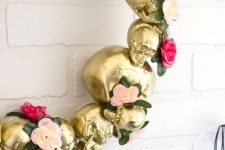 21 a gold skull wreath with flowers and greenery is an elegant and refined Halloween decoration