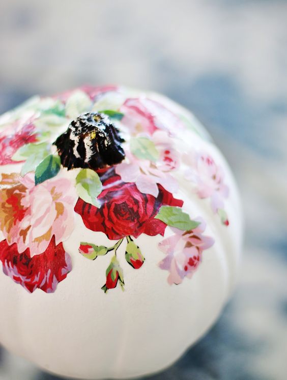 a white pumpkin with pink and red decoupage blooms and a black stem is a gorgeous idea for the fall and Thanksgiving