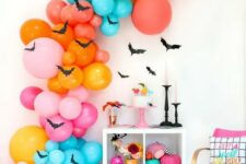 28 an oversized colorful balloon garland with bats, bright books and pumpkins for Halloween decor