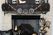 32 glam black and gold Halloween decor – an artwork with gold bats, a gold garland, gold candles, pumpkins and black mesh