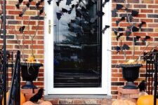 35 simple and stylish Halloween porch decor with heirloom pumpkins, blackbirds and bats on the walls and door