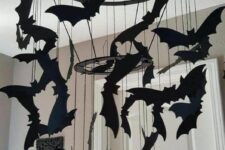 37 a black chandelier with black paper bats hanging down is a lovely mobile idea for any Halloween space