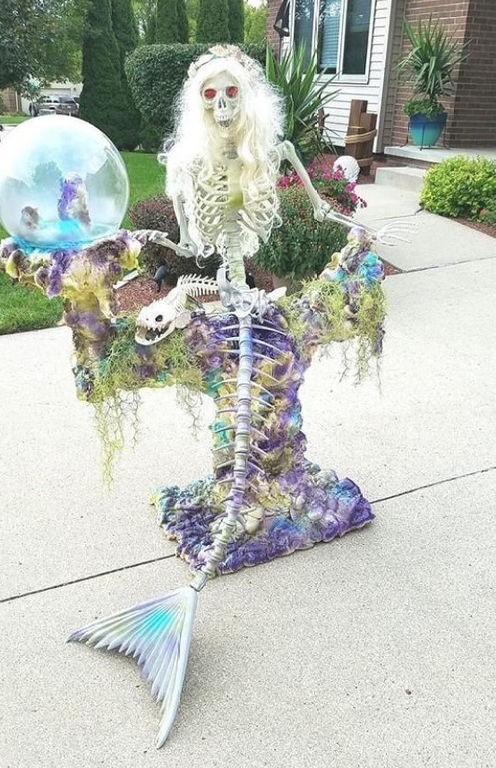 A super eye catchy mermaid skeleton with seashells and moss is a cool idea for Halloween decor but in an unusual way