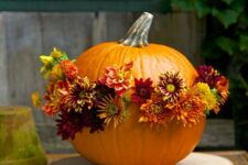 44 an orange pumpkin decorated with seasonal blooms in orange, burgundy and yellow is amazing for fall decor