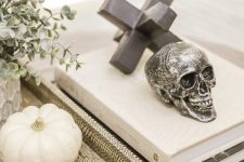 49 style your coffee table with a skull and a couple of pretty black and white pumpkins for modern Halloween decor