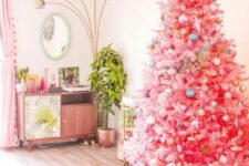 03 a bold pink Christmas tree decorated with various pastel ornaments and topped with a gold star topper is awesome