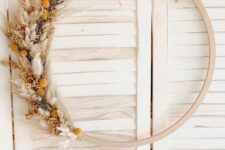 05 a boho Thanksgiving wreath of a wooden hoop, various dried grasses and blooms is a chic solution