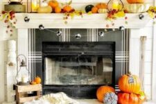 06 a bright and fun Thanksgiving mantel with bold pumpkins, bright leaves, candle lanterns and a plaid ball garland