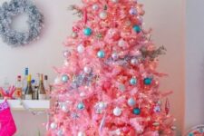 08 a candy pink Christmas tree with neutral, metallic and blue ornaments and lights looks very sweet and very cute