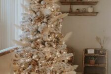 08 an amazing neutral boho Christmas tree decorated with pampas grass, gold and metallic ornaments, white ones and lights