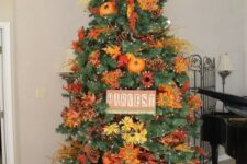 11 a gorgeous and bright Thanksgiving tree with lights, pinecones, bright faux blooms and leaves, branches, a sign and pumpkins