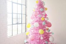 11 a hot pink Christmas tree decorated with balloons of various colors is a super fun and bold idea for celebrating