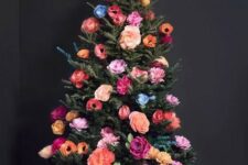 13 a beautiful and colorful Christmas tree decorated with faux blooms all the shades possible is a cool out of the box idea
