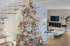 14 a beautiful and delicate flocked Christmas tree with white, blush, mauve faux blooms, lights and twigs is a very romantic and refined idea