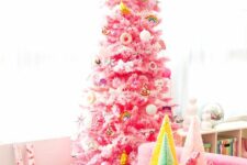 17 a pink Christmas tree decorated with various bold ornaments food-themed and many others is a fun and cool idea