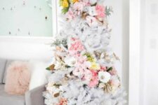 19 a delicate white Christmas tree with pink, white and yellow florals covering it in a swirl, with pale greenery is an out of the box idea
