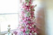 19 a pink Christmas tree decorated with white and gold ornaents, with fabric blooms is a stylish idea for a glam space