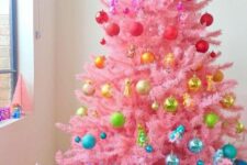 21 a pink christmas tree styled like a rainbow is a fun and cool idea for a bright holiday space