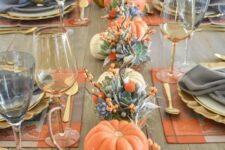 24 a bright modern Thanksgiving table with pumpkins, succulents, berries and orange placemats and grey napkins and gold glasses