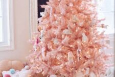 26 an adorable blush pink Christmas tree with lights, animals and birds plus a blush chunky knit blanket at the base