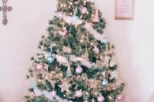 27 a Christmas tree decorated with pastel green and pink ornaments, stars, lights and fluffy garlands plus a star topper