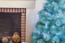 27 a beautiful modern turquoise Christmas tree with blue lights in a basket is a gorgeous solution, it requires no ornaments as it stands out itself