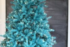 28 a gorgeous bold turquoise Christmas tree with lights in a basket – you don’t need any decor as you alreayd have a bold color statement
