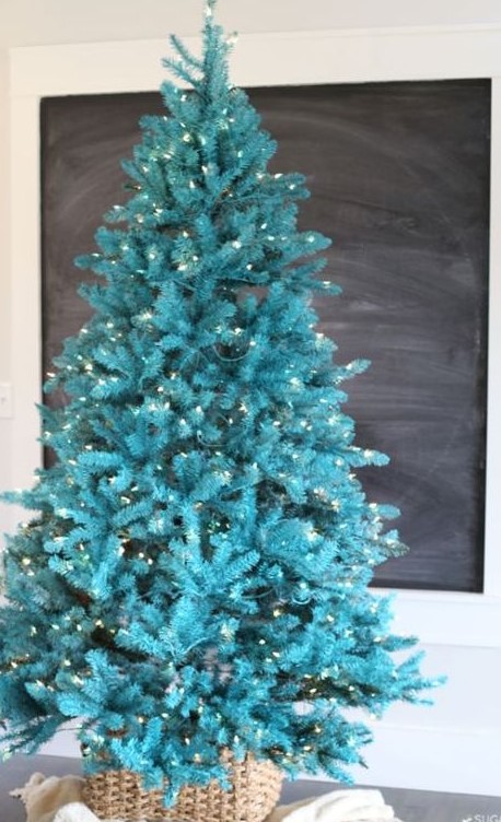 A gorgeous bold turquoise Christmas tree with lights in a basket   you don't need any decor as you alreayd have a bold color statement