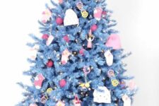 29 a blue Christmas tree decorated with socks, beanie, little plush toys and red and yellow ornaments
