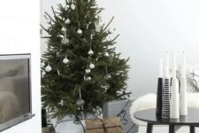 34 a modern Scandi Christmas tree with white, clear and metallic ornaments and no lights for a laconic look