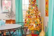 36 a mellow yellow Christmas tree with pink, green, red ornaments of vintage style is a super bold decor solution