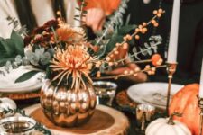 40 orange woven placemats, orange blooms and berries and orange pumpkins add color and coziness to the Thanksgiving tablescape
