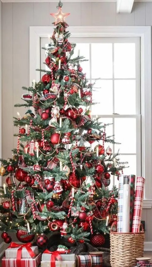 A vintage inspired Christmas tree with red ornaments, lights and candy candes looks bold and catchy