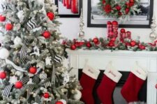 46 a flocked Christmas tree with red and white ornaments, with lights and black and white striped ribbons