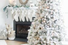 56 a magical flocked Christmas tree with gold, white and silver ornaments, pinecones, greenery, lights and grasses is amazing