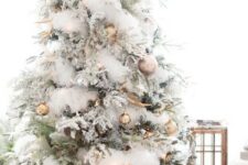 57 an enchanting Christmas tree with gold and copper ornaments, natlers, white faux fur garlands, antlers and pinecones is veyr glam-like
