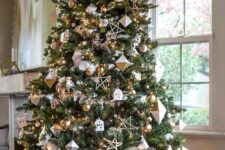 58 a modern glam Christmas tree with white and gold ornaments, faceted rhomb ornaments, stars and mini houses is cool
