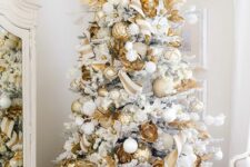 61 a super glam white Christmas tree with white, silver and gold ornaments, gold leaves and beads is a gorgeous idea