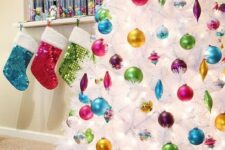 63 if you love bold colors, rock a pure white tree with bold ornaments to accentuate them