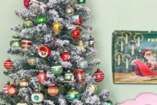 66 a flocked Christmas tree decorated with colorful vintage Christmas ornaments placed into a drum is a creative idea