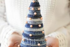 a bleached and navy denim cone Christmas tree decorated with pearls and topped with a felt snowflake