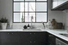 a modern black kitchen design with a window
