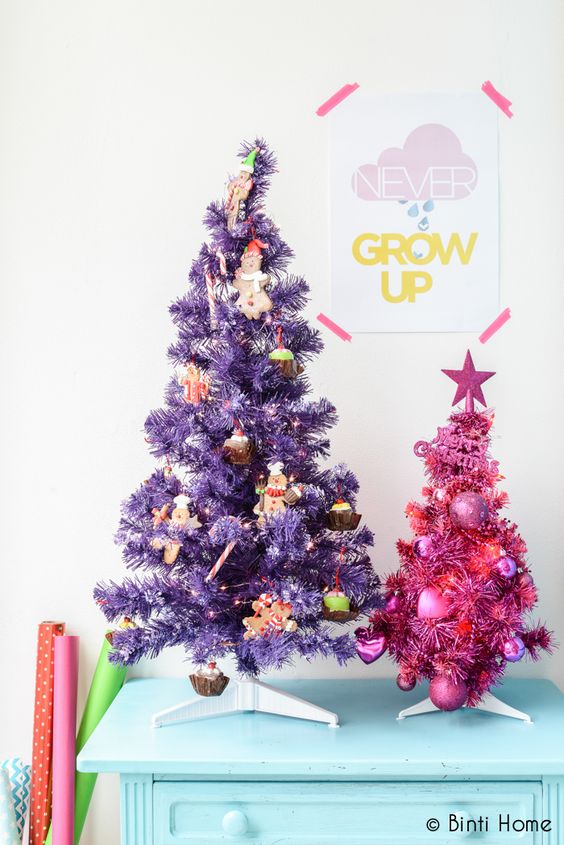 A duo of pretty Christmas trees   a purple and a pink one, with food themed ornaments and heart shaped ones