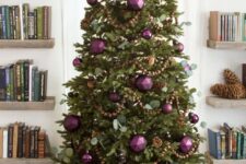 a fabulous Christmas tree decorated with usual and faceted Christmas ornaments, greenery, wooden beads and pinecones is a fresh take on traditional rustic decor