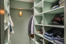 a mint green closet with shelves and drawers and built-in lights is a stylish idea with a soft touch of color