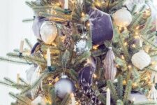 a refined Christmas tree decorated with silver and grey ornaments, with lilac velvet ribbon and candles plus lights is fantastic