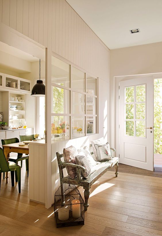 A welcoming and light filled entryway with a window to the dining room to connect the spaces and make them look bigger